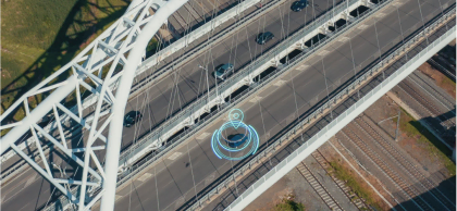 Aerial view of a connected vehicle on a modern bridge with digital geolocation graphics, symbolizing road safety, telematics, and vehicle tracking technology
