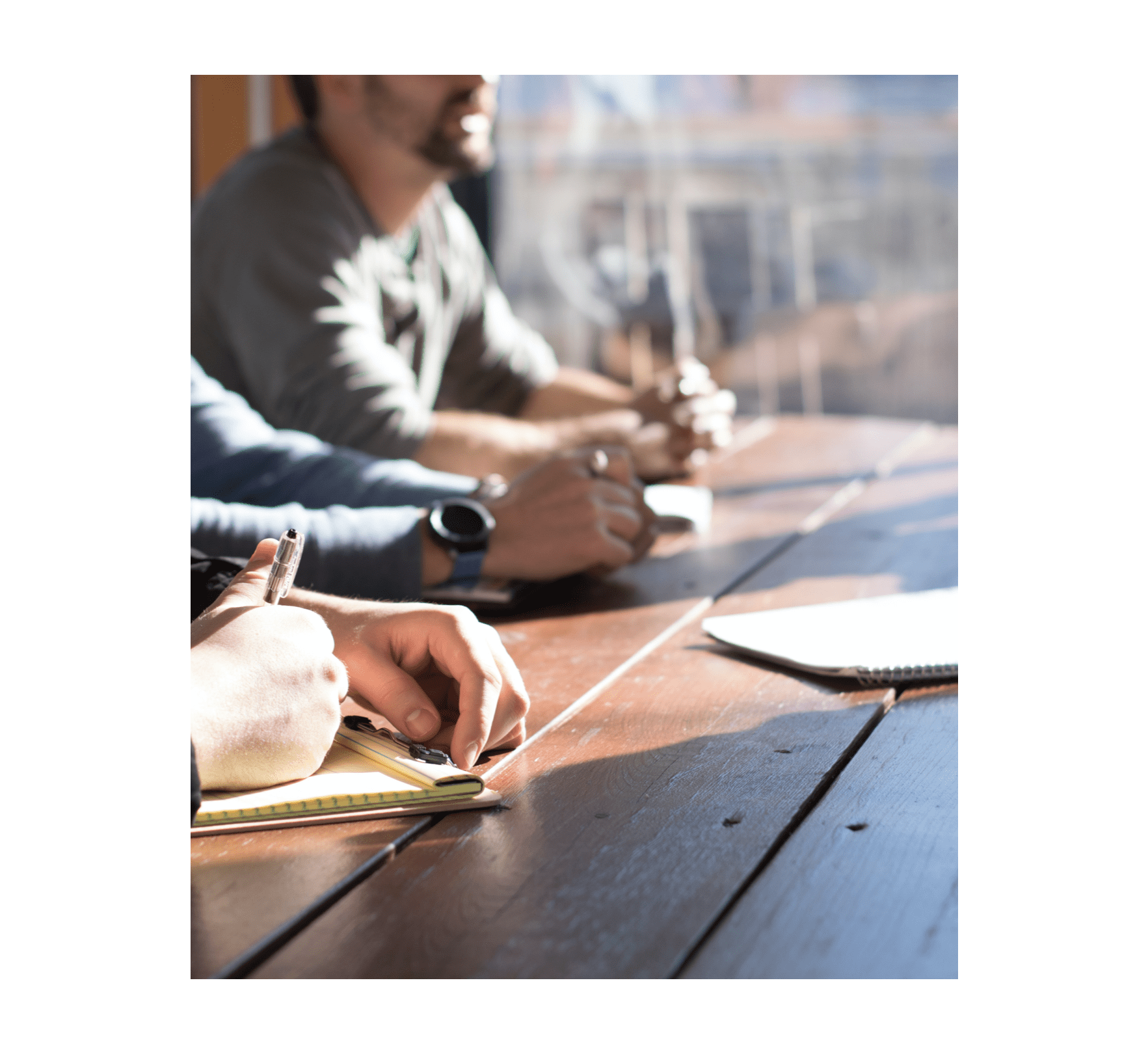 Team training session with notebooks and discussions at a wooden table